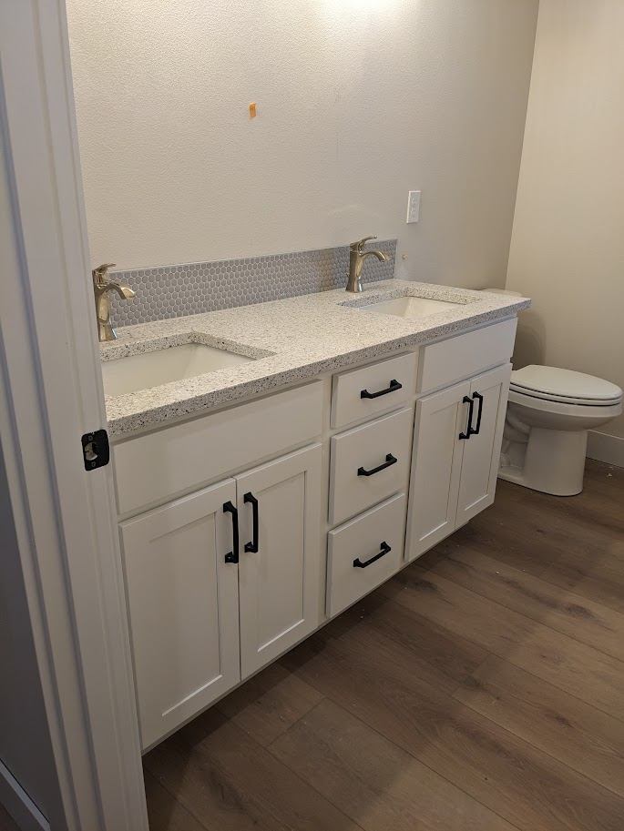Double-sink bathroom vanity with white shaker cabinetry