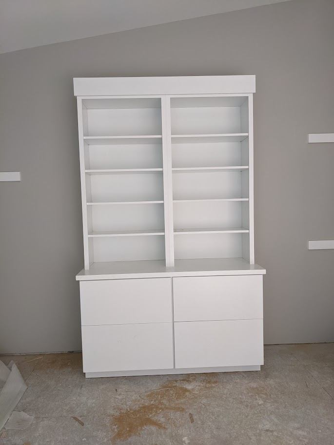 Built-in bookcase and cabinet unit painted white