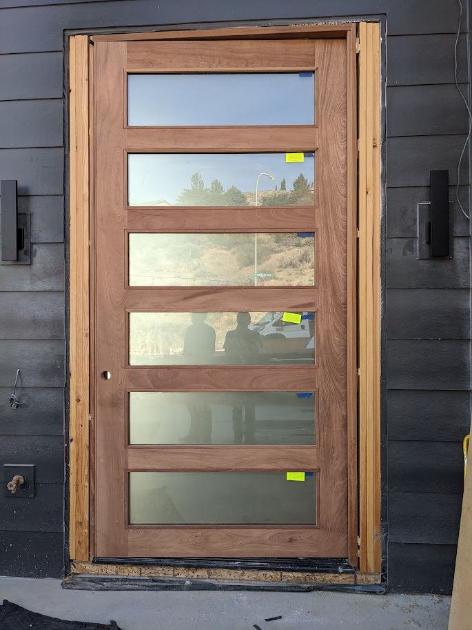 Custom wood-and-glass exterior entry door installation
