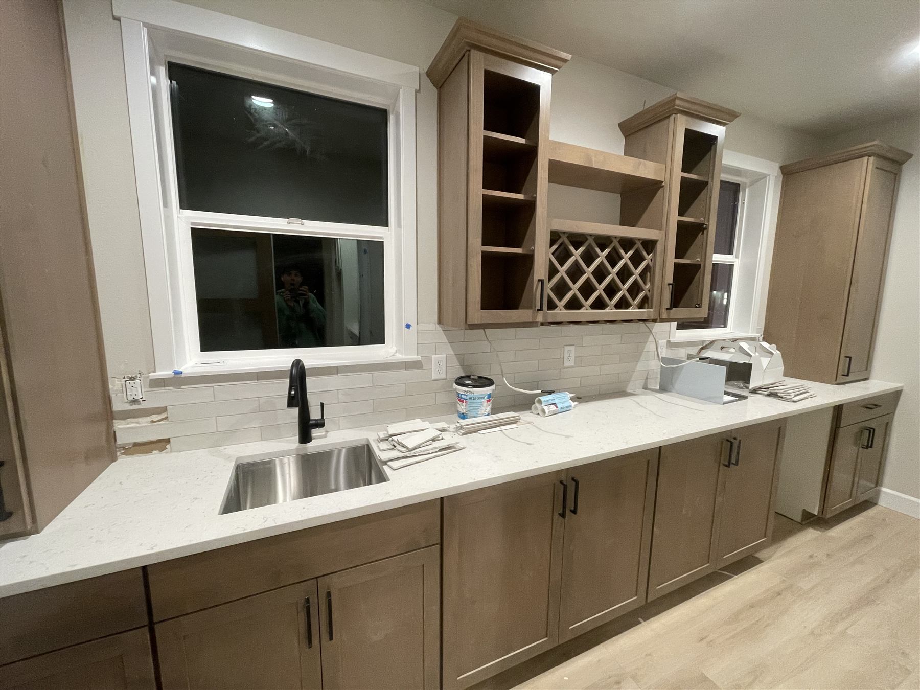 Kitchen cabinetry with wine rack lattice being installed