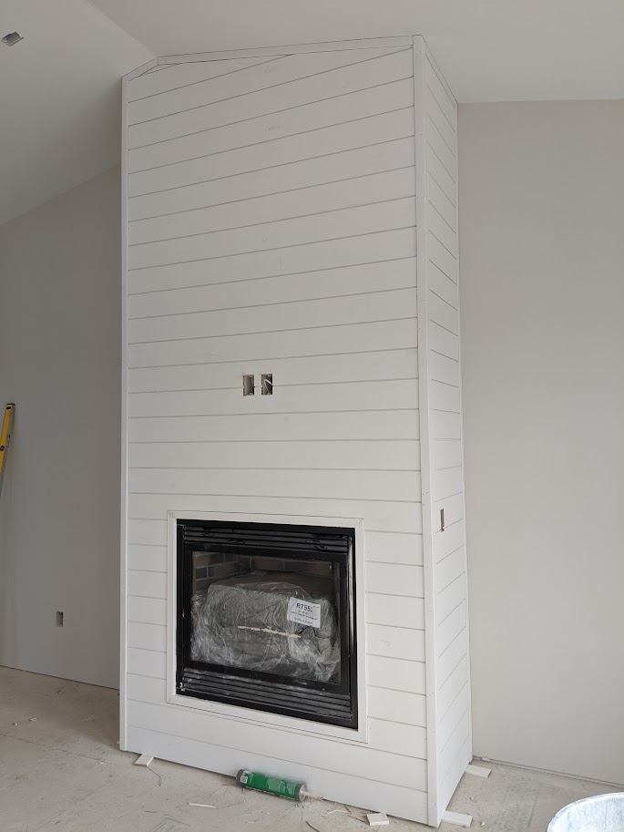 Shiplap fireplace surround being installed