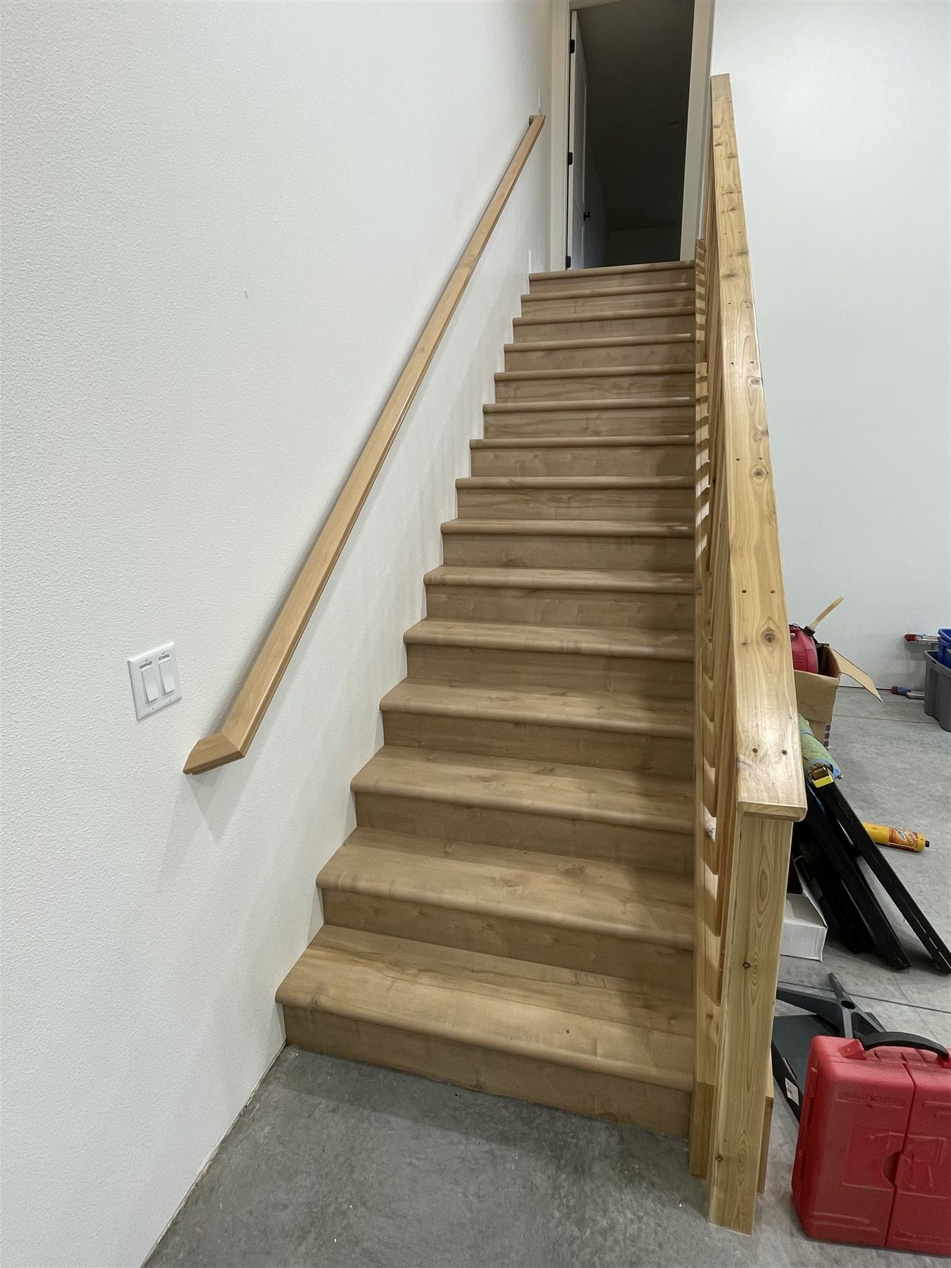 Staircase with natural wood treads and handrail