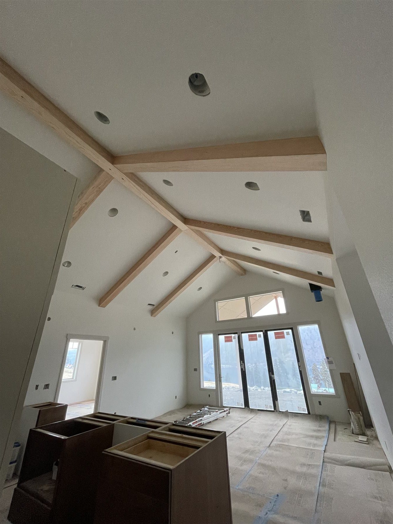 Vaulted beam ceiling over unfinished cabinet shells