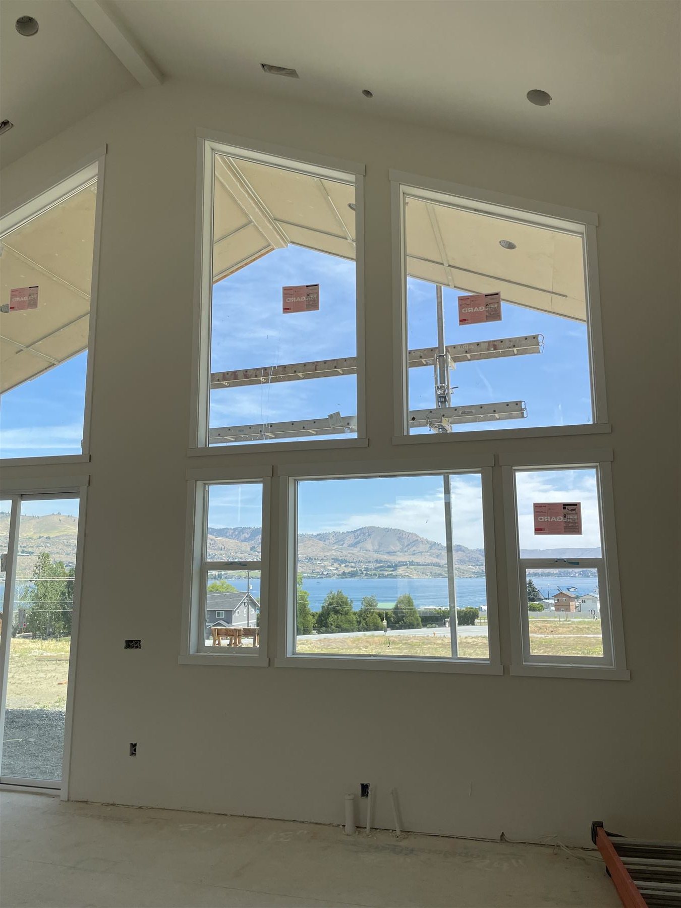 Window trim being installed with a lake view beyond