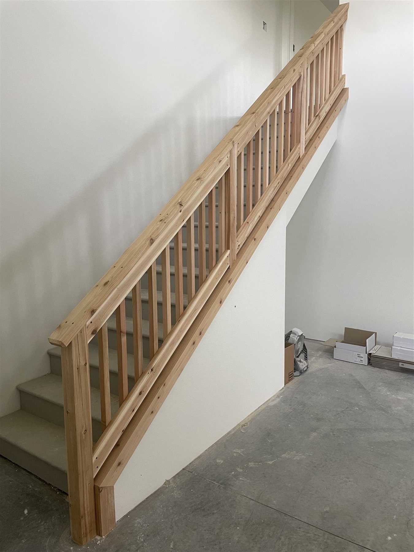 Diagonal wood stair railing under construction