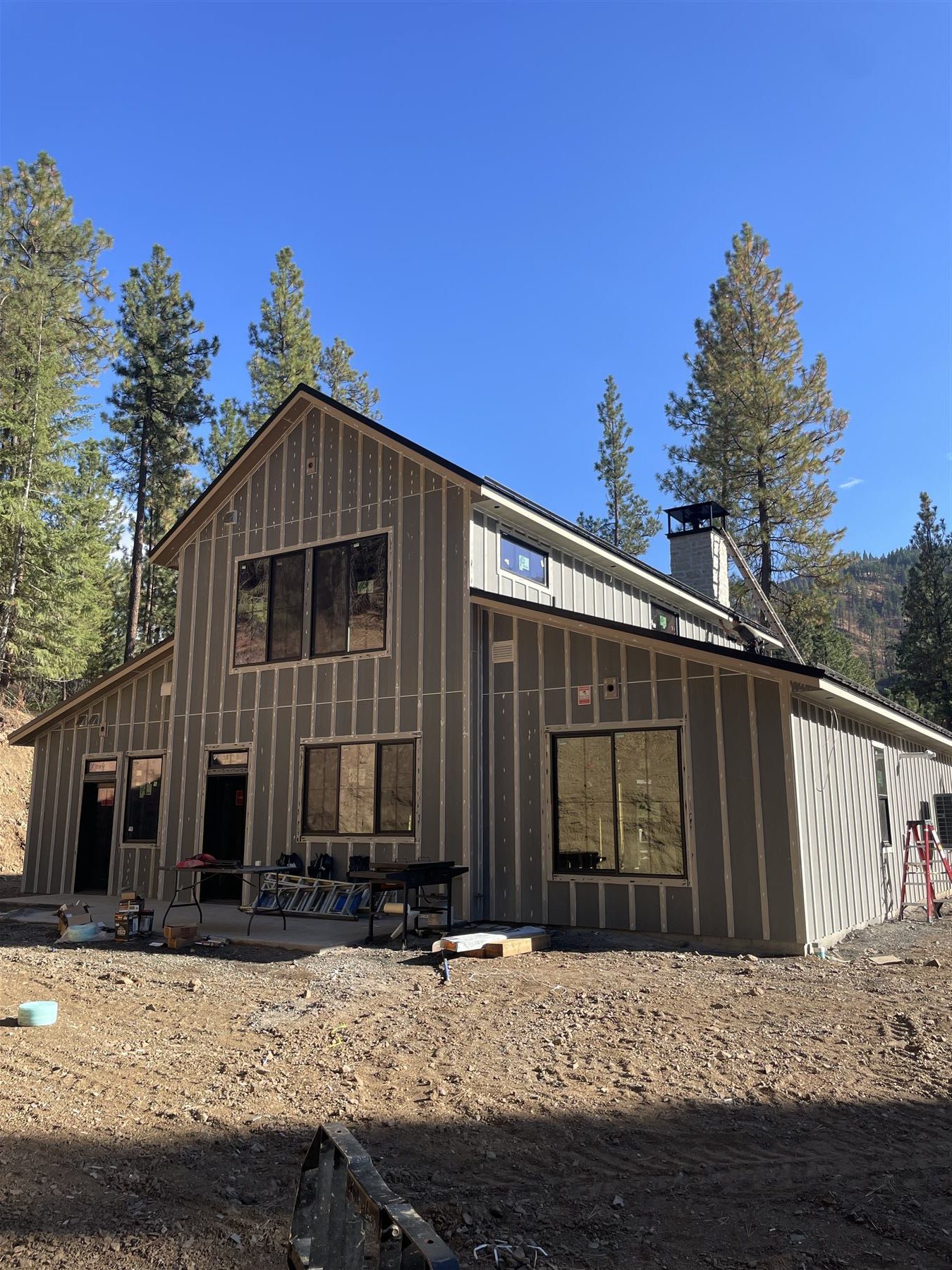 Board-and-batten home addition front view with a large window wall