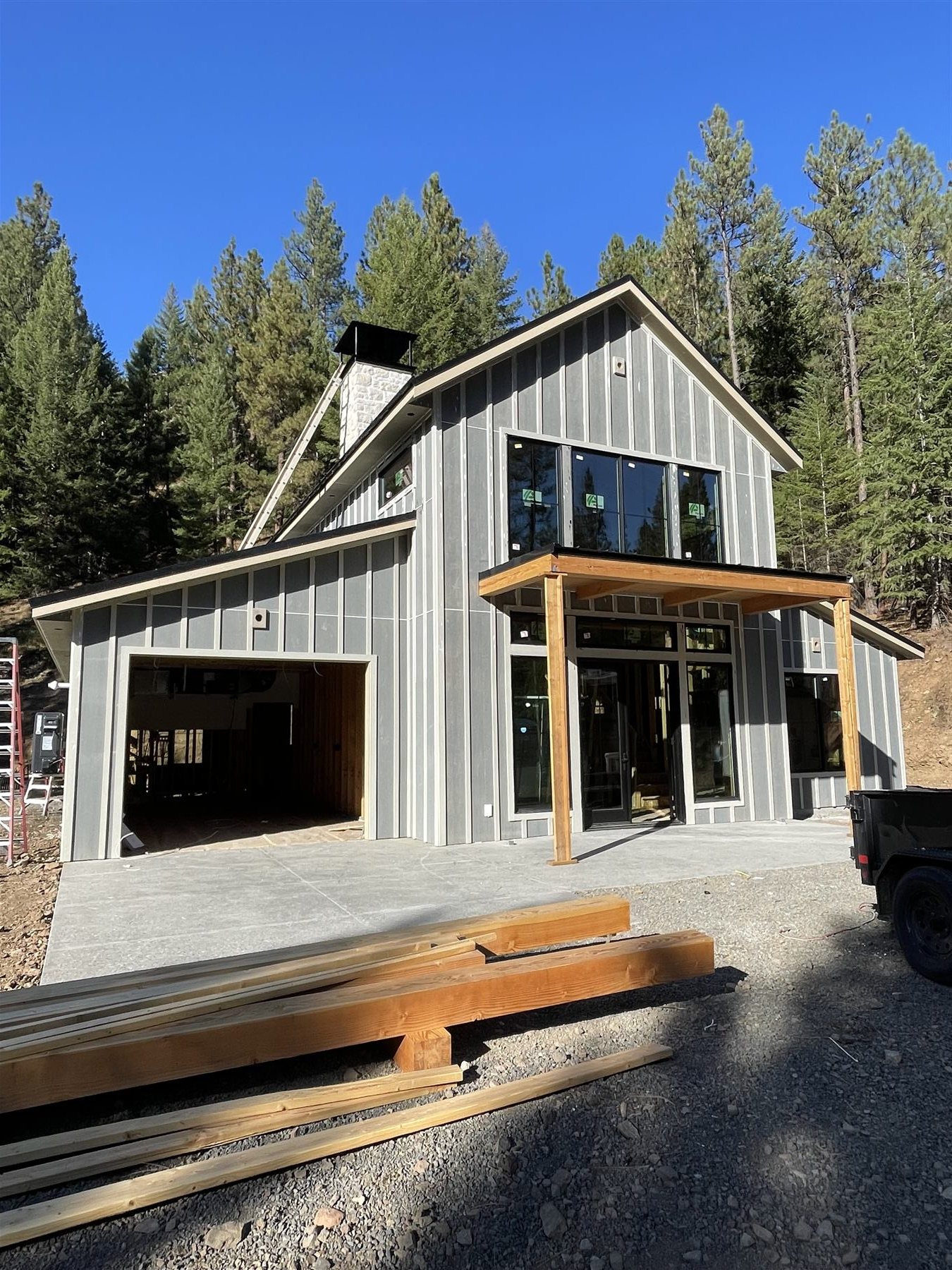 Covered entry addition with timber posts and an open garage bay