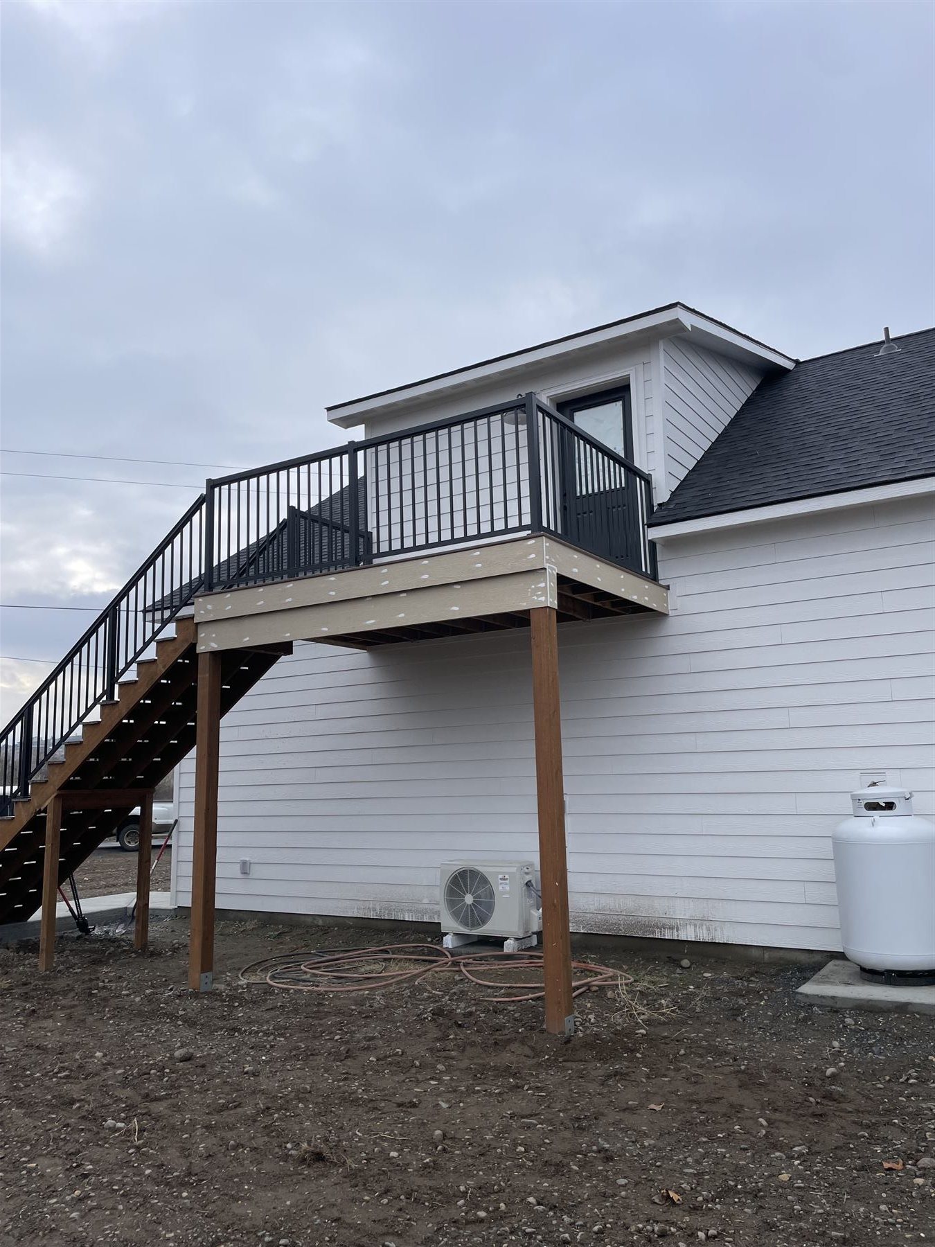 Deck addition beneath a dormer