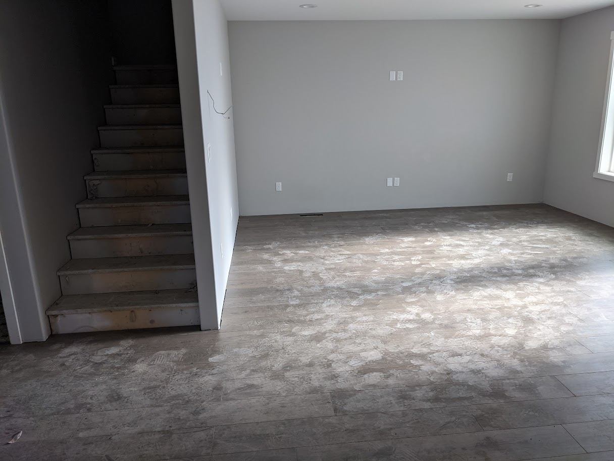 Interior room mid-renovation with new subfloor and flooring work in progress