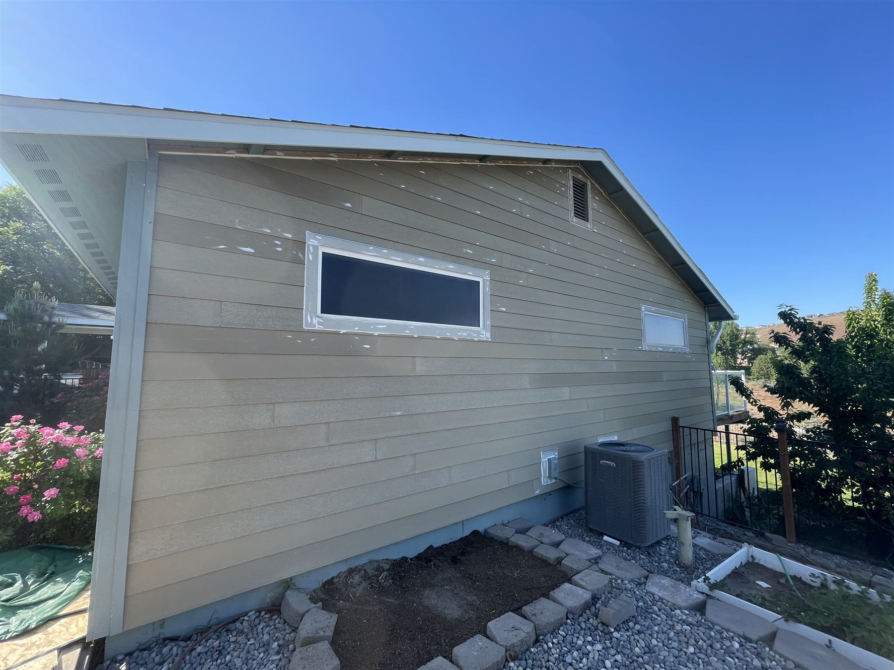 Addition exterior with freshly installed lap siding