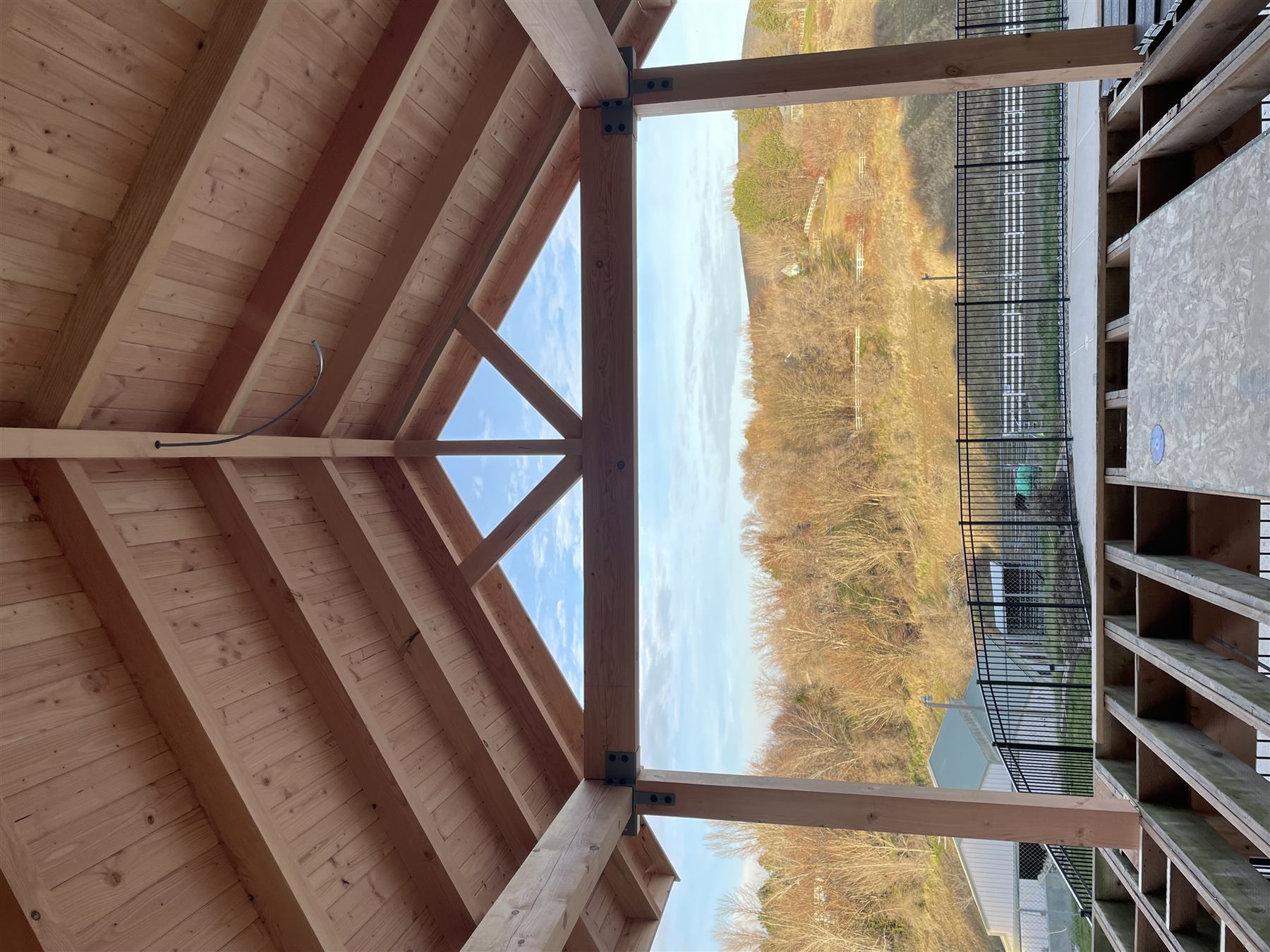 Vaulted timber-frame pergola patio cover with open truss detail
