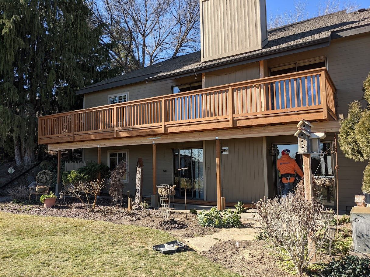 Two-story cedar deck addition with railing
